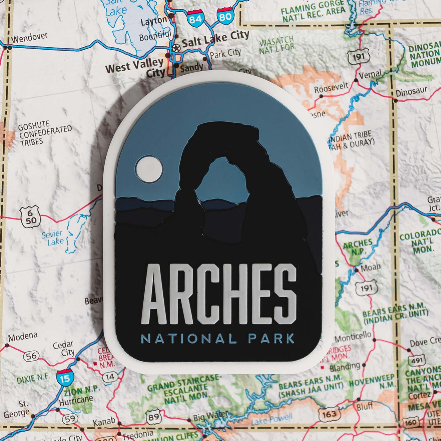 Arches National Park fridge magnet featuring the iconic arch silhouette against a blue and black background.