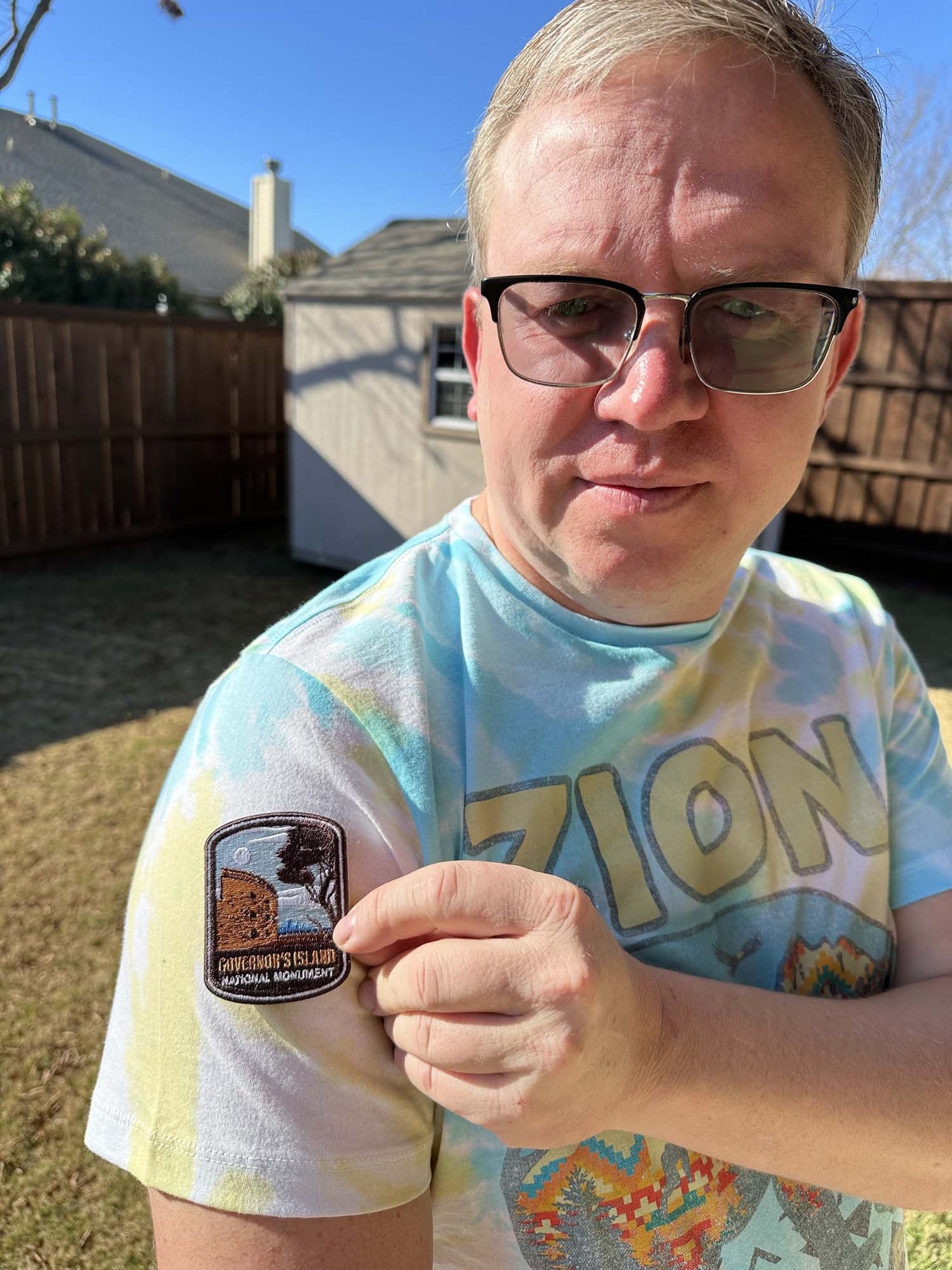 Governor’s Island National Monument iron-on patch displayed on a person's shirt sleeve in an outdoor setting.
