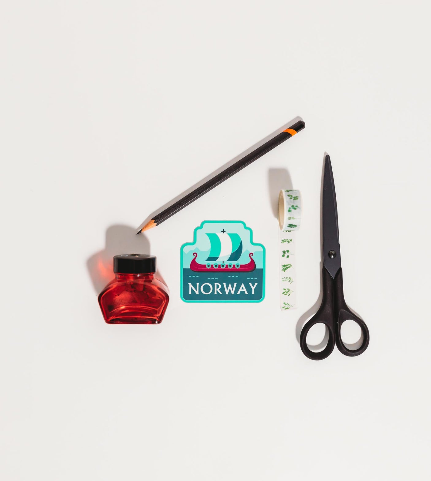 Norway sticker featuring a ship design, surrounded by scissors, a pencil, and a red ink bottle.