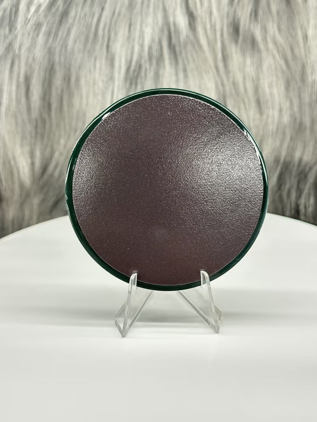 Roswell, NM PVC fridge magnet with a dark brown back and green border, displayed on a clear stand.