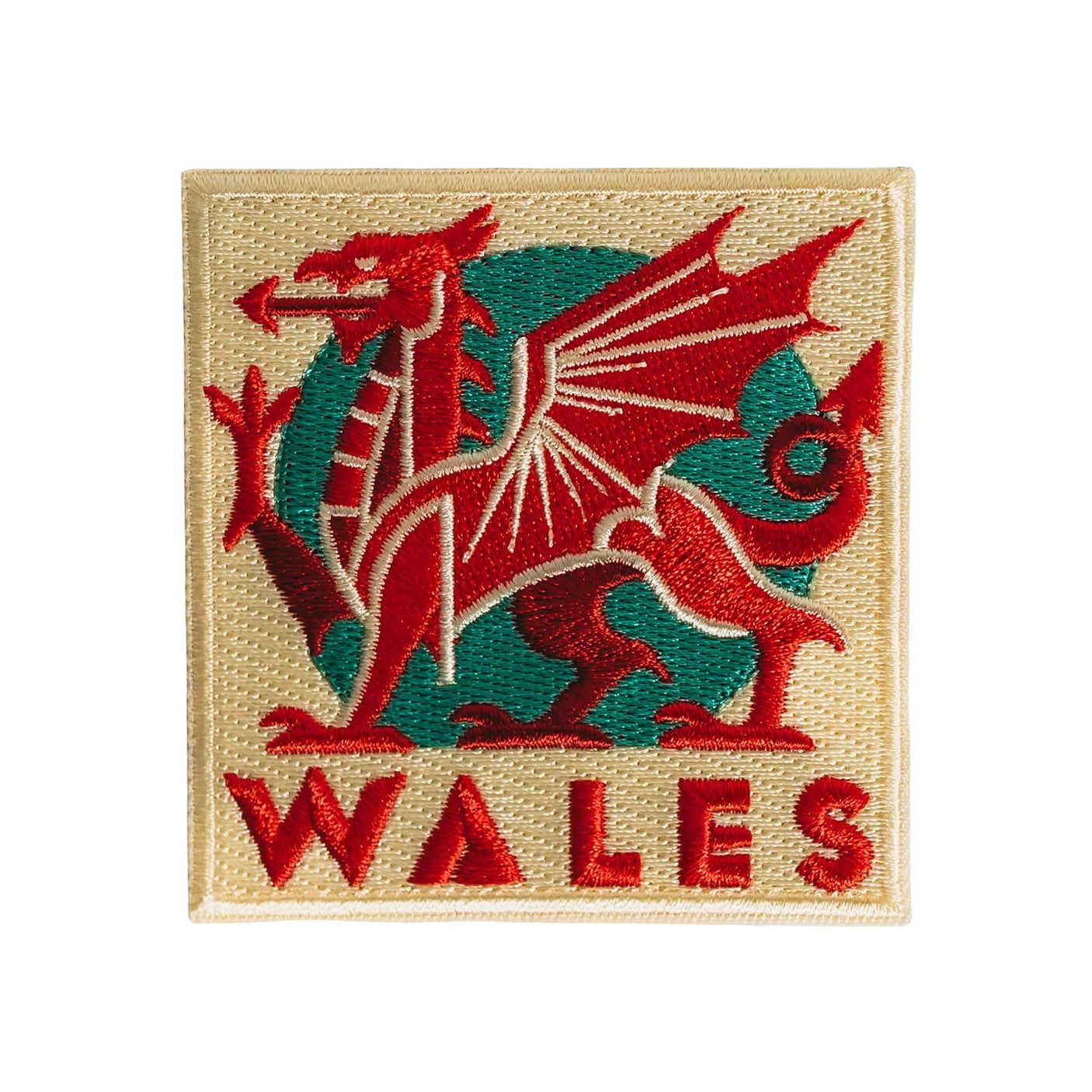 Wales patch featuring a red dragon on a green and cream background with the word "Wales" at the bottom.