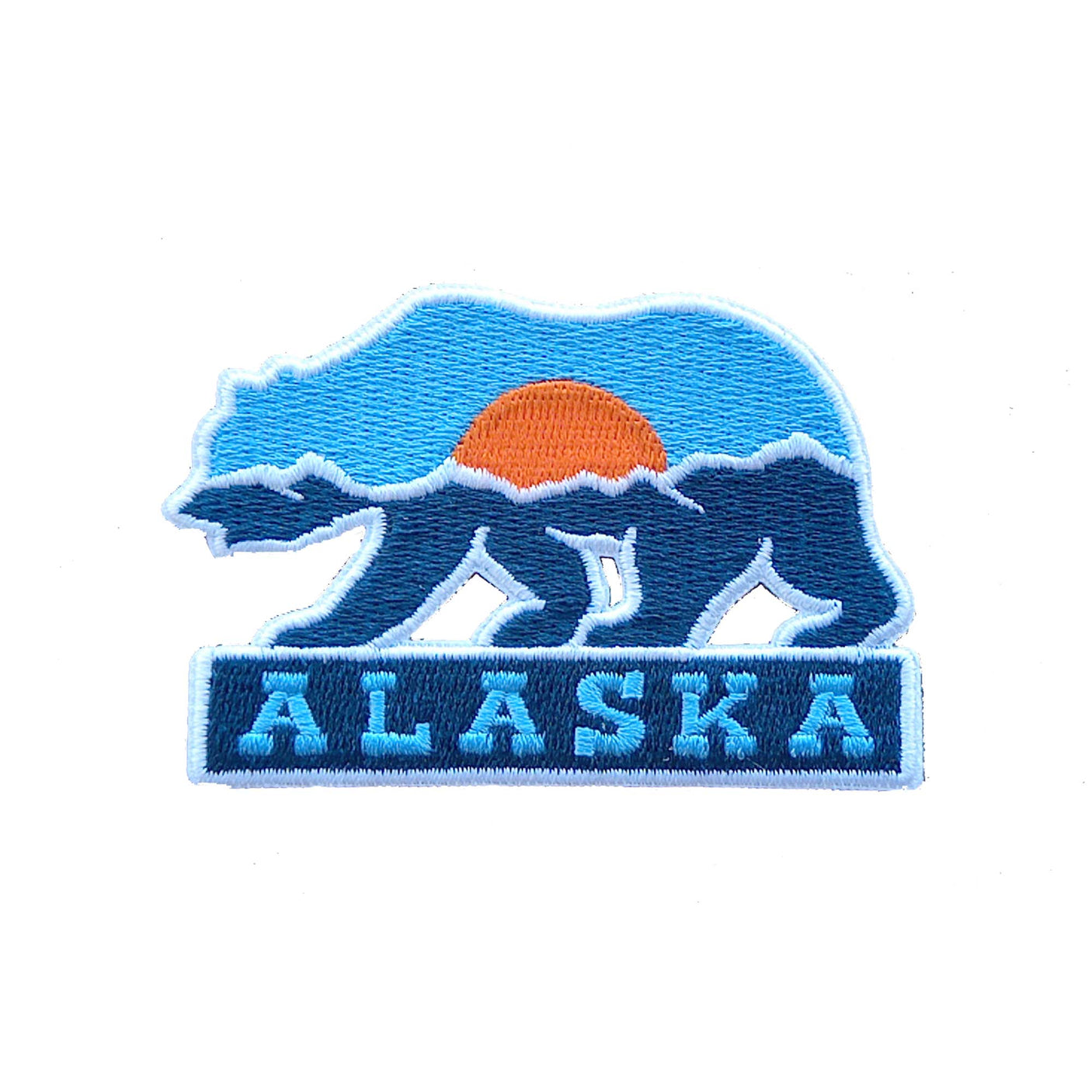 Alaska patch featuring a bear silhouette with a blue and orange sunset background and "ALASKA" text at the bottom.