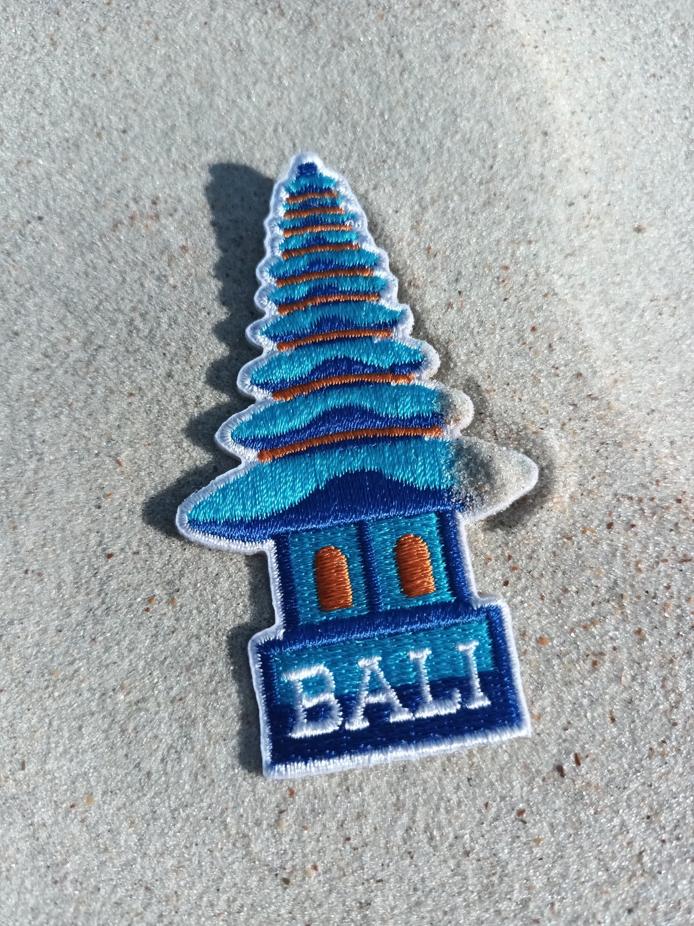 Bali Indonesia patch featuring a blue temple design with orange accents on a sandy background.