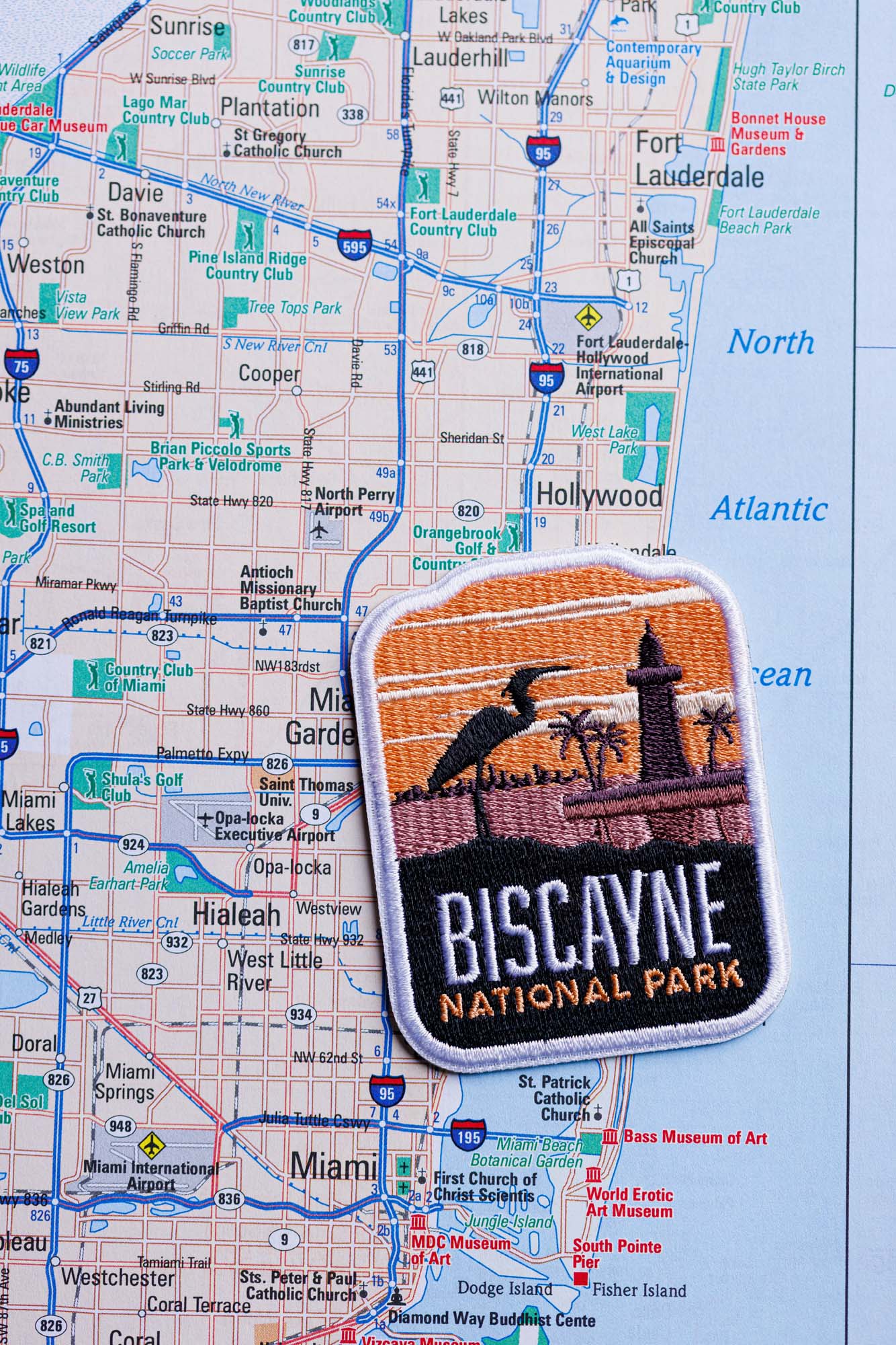 Biscayne National Park patch featuring a lighthouse and bird, placed on a detailed map of Miami.