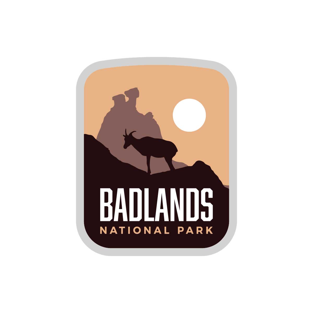 Badlands National Park sticker featuring a silhouette of a goat against a sunset backdrop with rock formations.