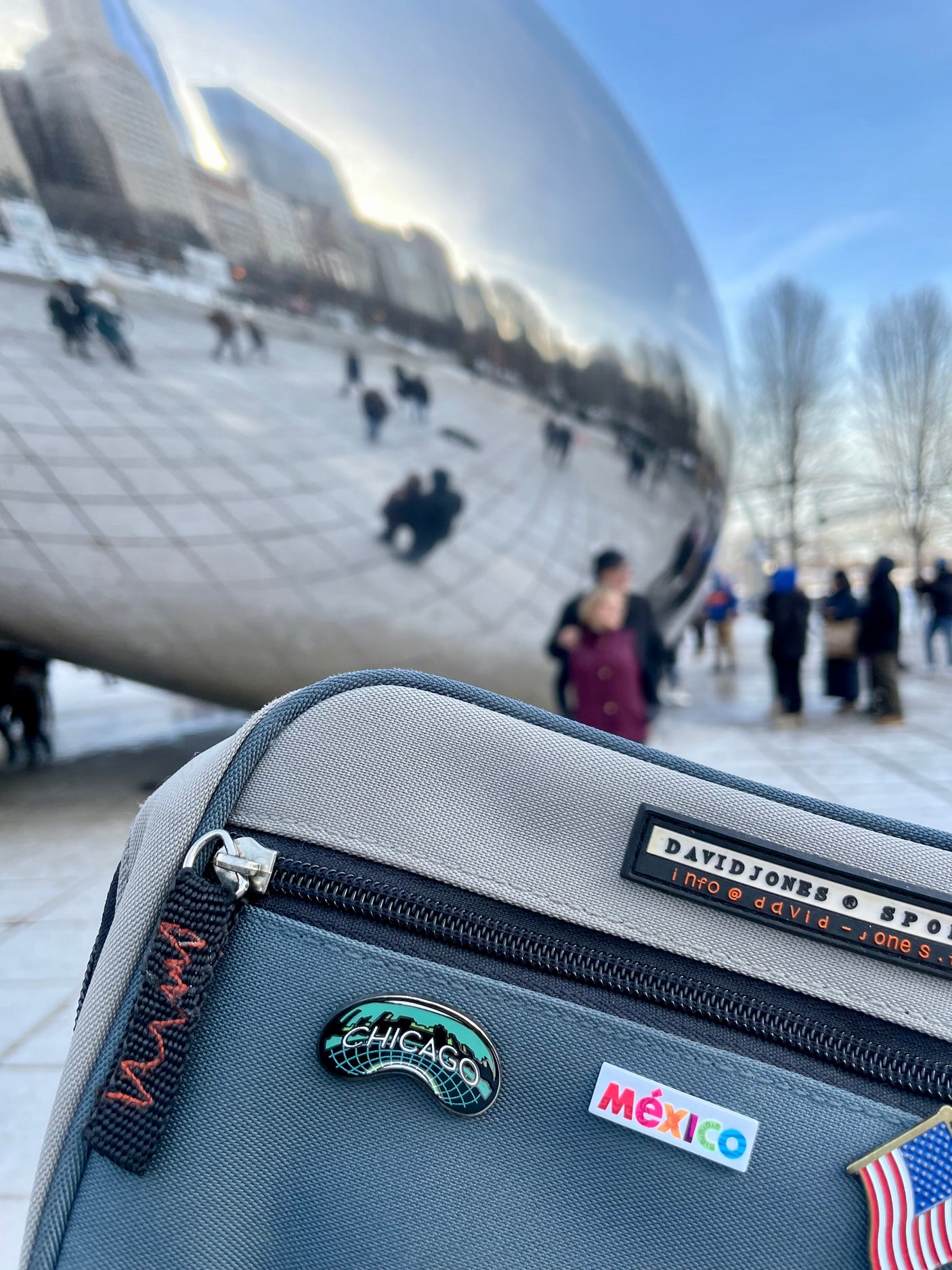 Chicago enamel pin attached to a gray bag, featuring a green and black design, with the city name "Chicago" prominently di...