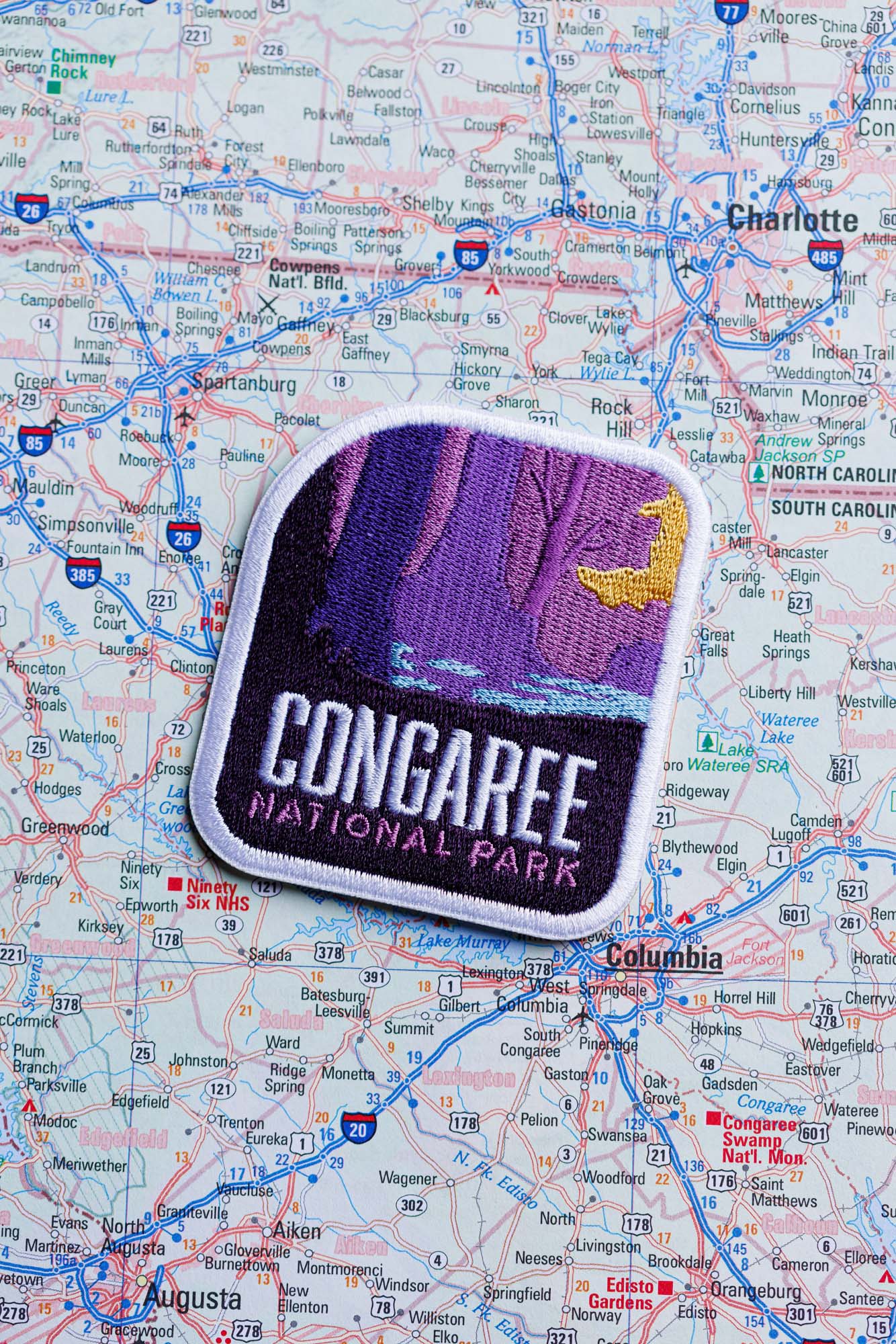 Congaree National Park patch featuring a purple and yellow design on a detailed map background.