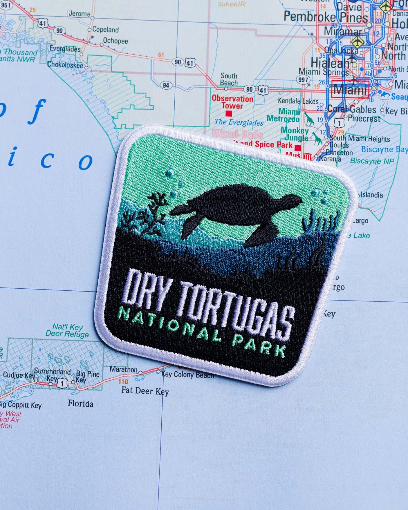 Dry Tortugas National Park patch featuring a turtle design on a blue and green background, placed on a map.