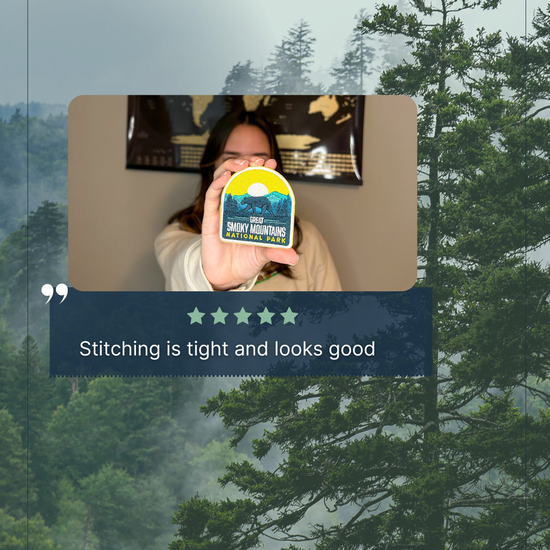 Great Smoky Mountains National Park patch displayed by a person, featuring vibrant colors and detailed stitching.
