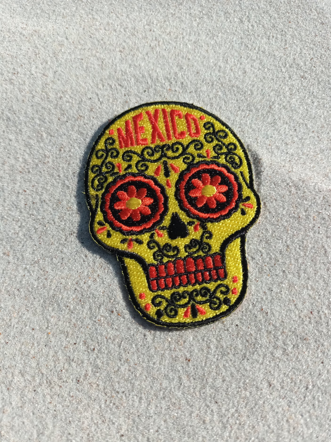 Mexico patch featuring a colorful skull design with floral accents and the word "Mexico" in red.