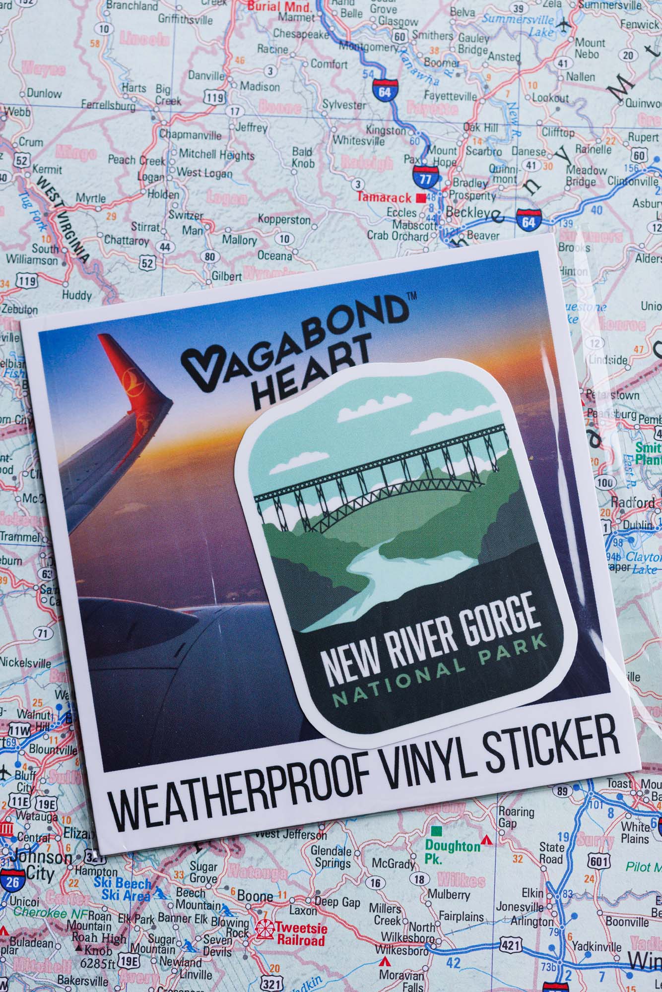 New River Gorge National Park sticker featuring a bridge and river design on a travel map background.