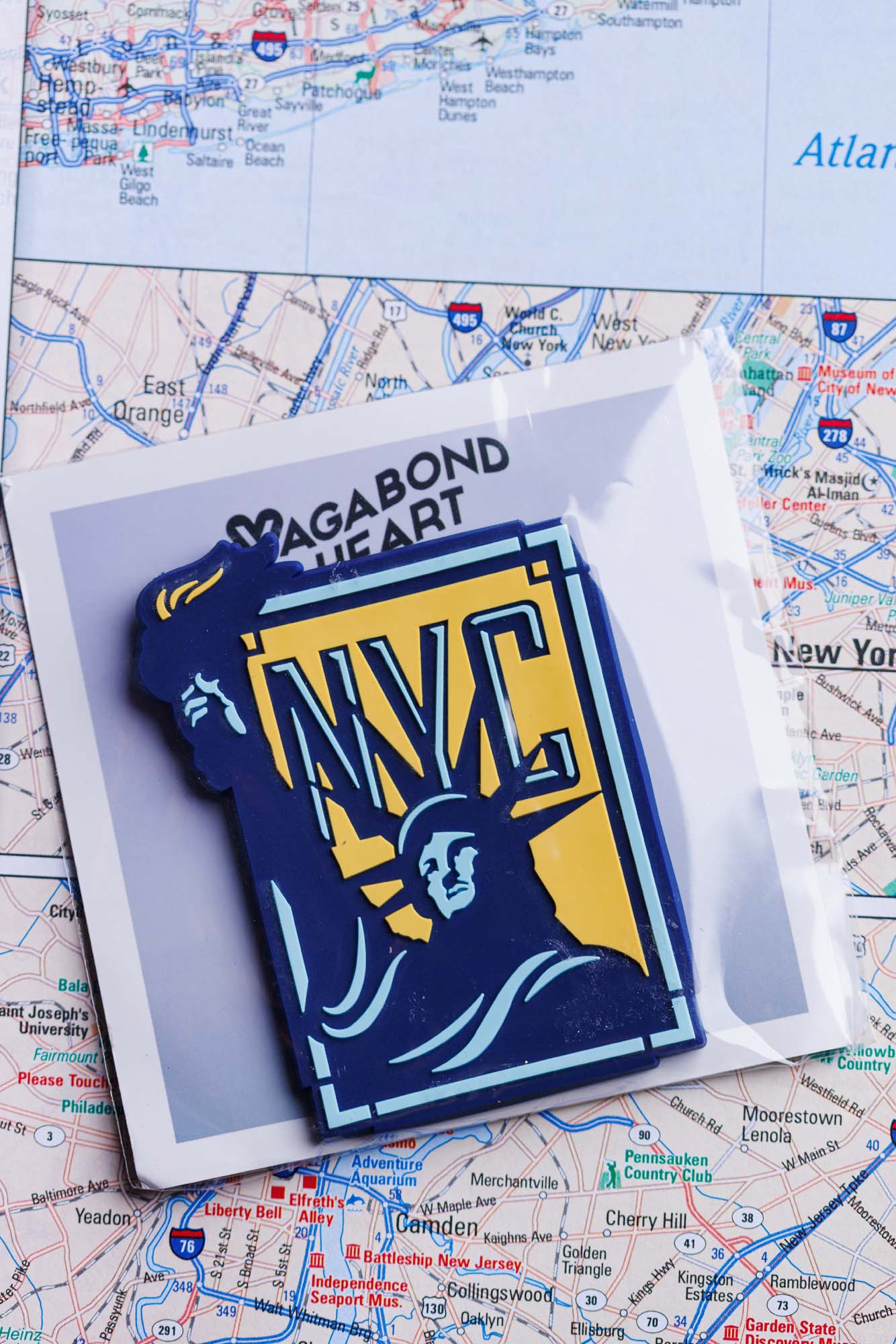 New York City PVC fridge magnet featuring the Statue of Liberty and NYC text on a map background.