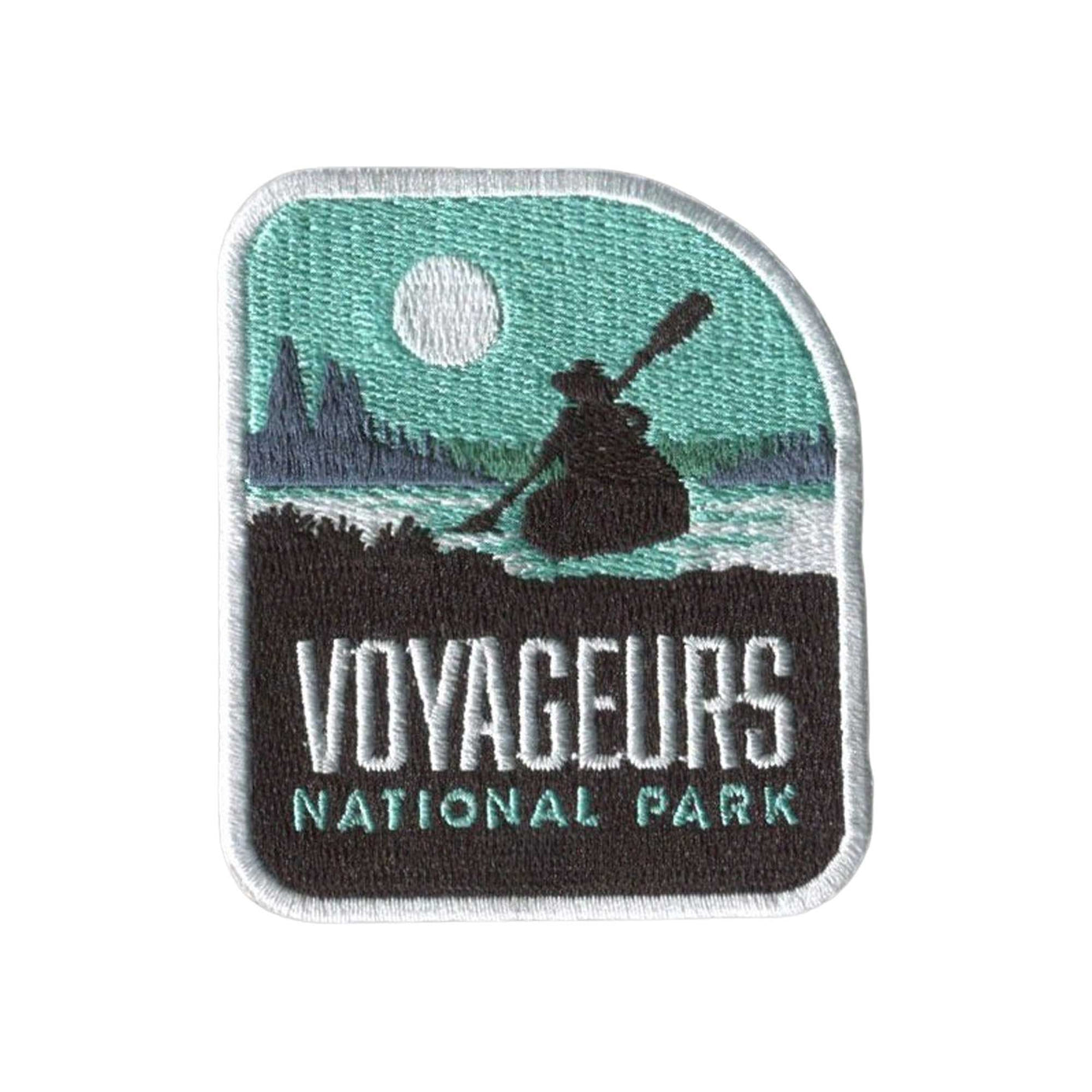 Voyageurs National Park patch featuring a canoeist, water, and moonlit landscape in teal and black colors.