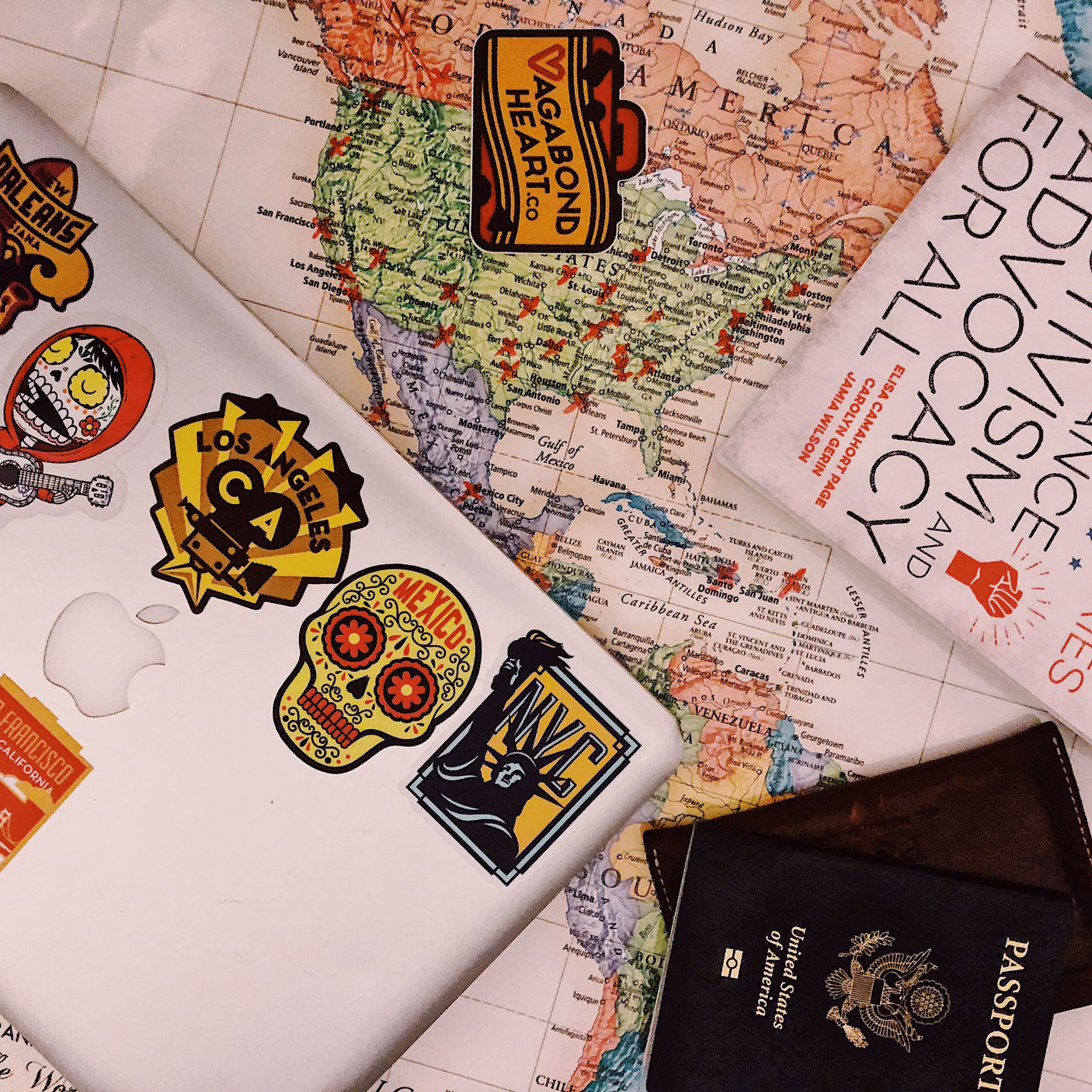 Joshua Tree National Park sticker on a laptop, surrounded by various colorful stickers and a map.