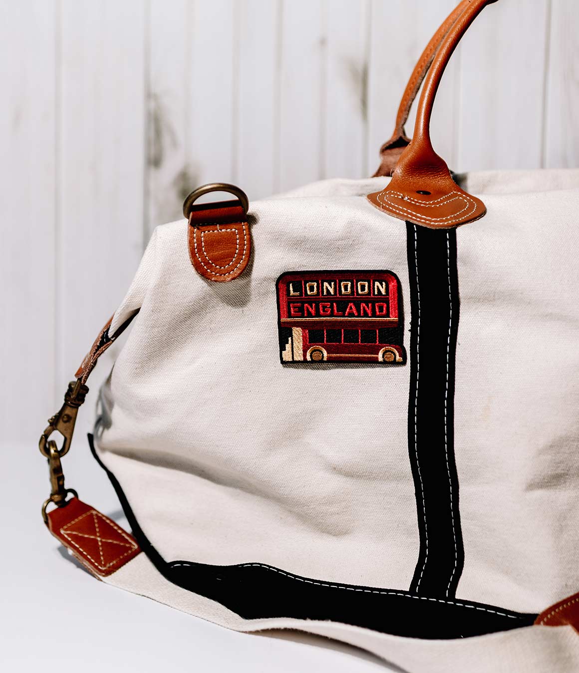 Wrangell - St. Elias National Park patch sewn onto a cream-colored bag with brown leather handles.