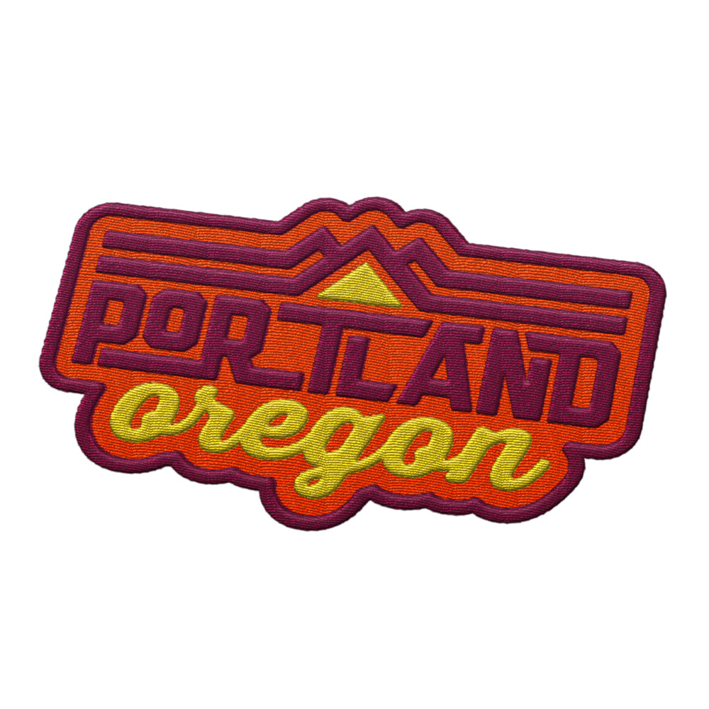 Portland Oregon patch featuring vibrant orange and yellow text with mountain graphics on a purple background.