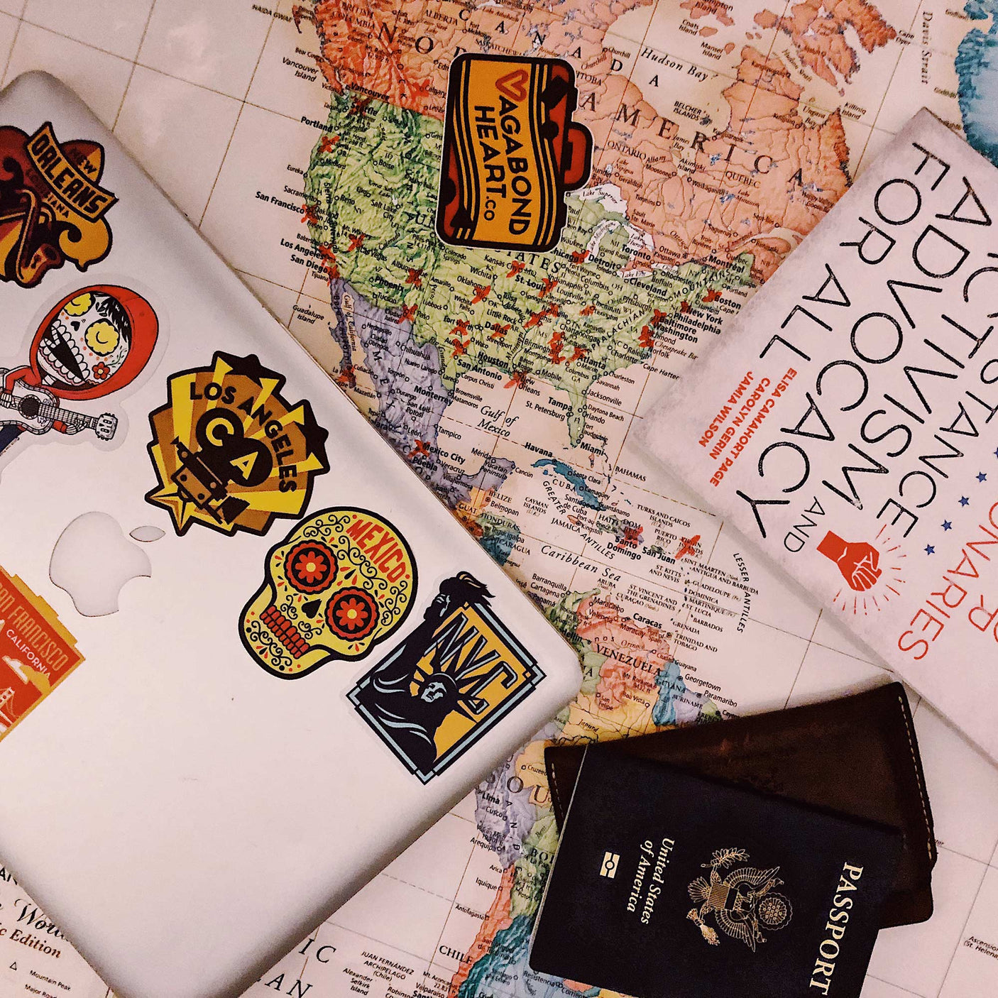 Chicago sticker featuring a vibrant design, placed on a silver laptop surrounded by travel items and a world map.