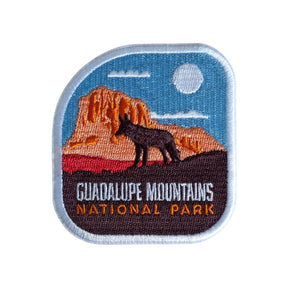 Guadalupe Mountains National Park patch featuring a coyote and mountain landscape with blue sky and sun.
