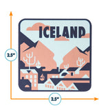 Iceland sticker featuring stylized mountains, houses, and trees in peach and navy colors, measuring 2.5 inches square.