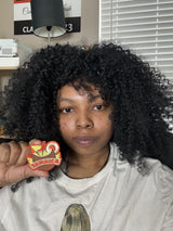 Jamaica patch held by a person with curly hair, featuring vibrant colors and a tropical design.