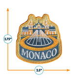 Monaco patch featuring a fountain design with gold, blue, and orange colors, measuring 2.75 inches by 2.5 inches.