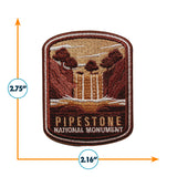 Pipestone National Monument iron-on patch featuring a waterfall and trees in earthy tones, measuring 2.75 by 2.16 inches.