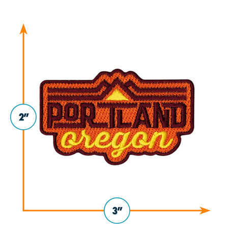 Portland Oregon patch featuring orange and yellow text with mountain graphics, measuring 2 inches by 3 inches.