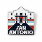 San Antonio pin featuring a stylized design with red, white, and blue colors, depicting a historic building and star.