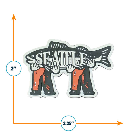 Seattle magnet featuring a fish held by two hands, measuring 3.25 inches wide and 2 inches tall.