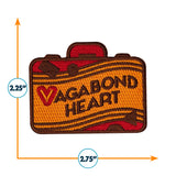 Vagabond Heart Wanderer patch featuring a suitcase design in orange and brown with embroidered text.