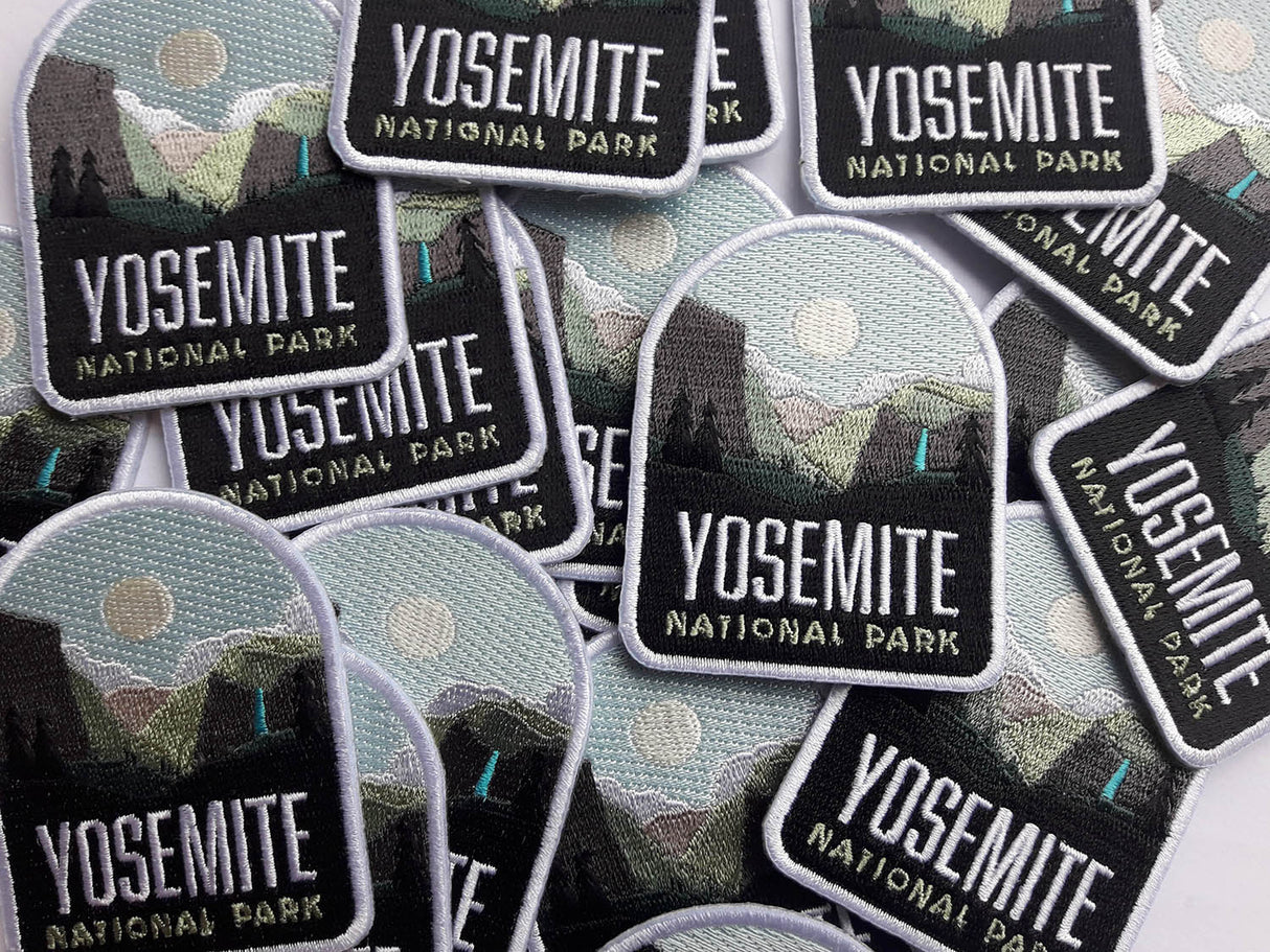 Yosemite National Park patches featuring a mountain landscape and moon, arranged in a scattered layout.