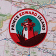 Prince Edward Island patch featuring a lighthouse design on a colorful map background.