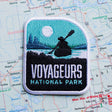 Voyageurs patch on a map background