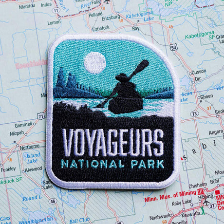 Voyageurs patch on a map background