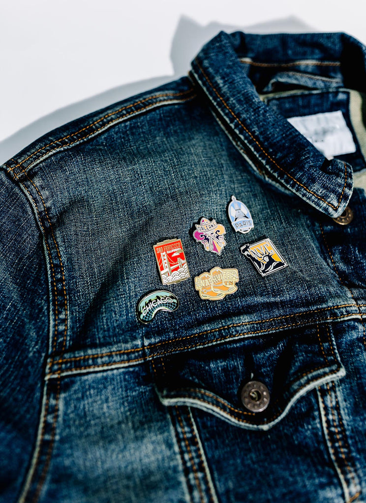 travel pins on a denim jacket